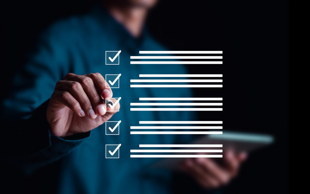 A businessman in a dark blue shirt is reaching forward to check off a box on a checklist that is overlaid in the forefront of the image.